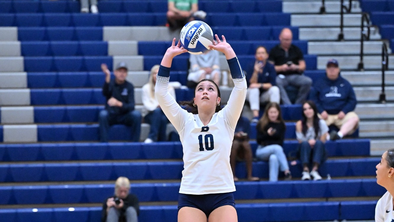 Camila Valenzuela sets a ball during a volleyball match