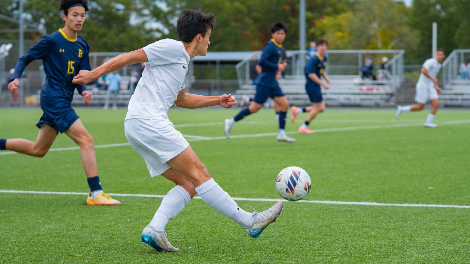 Maddox Yu crosses ball into the box during a soccer match