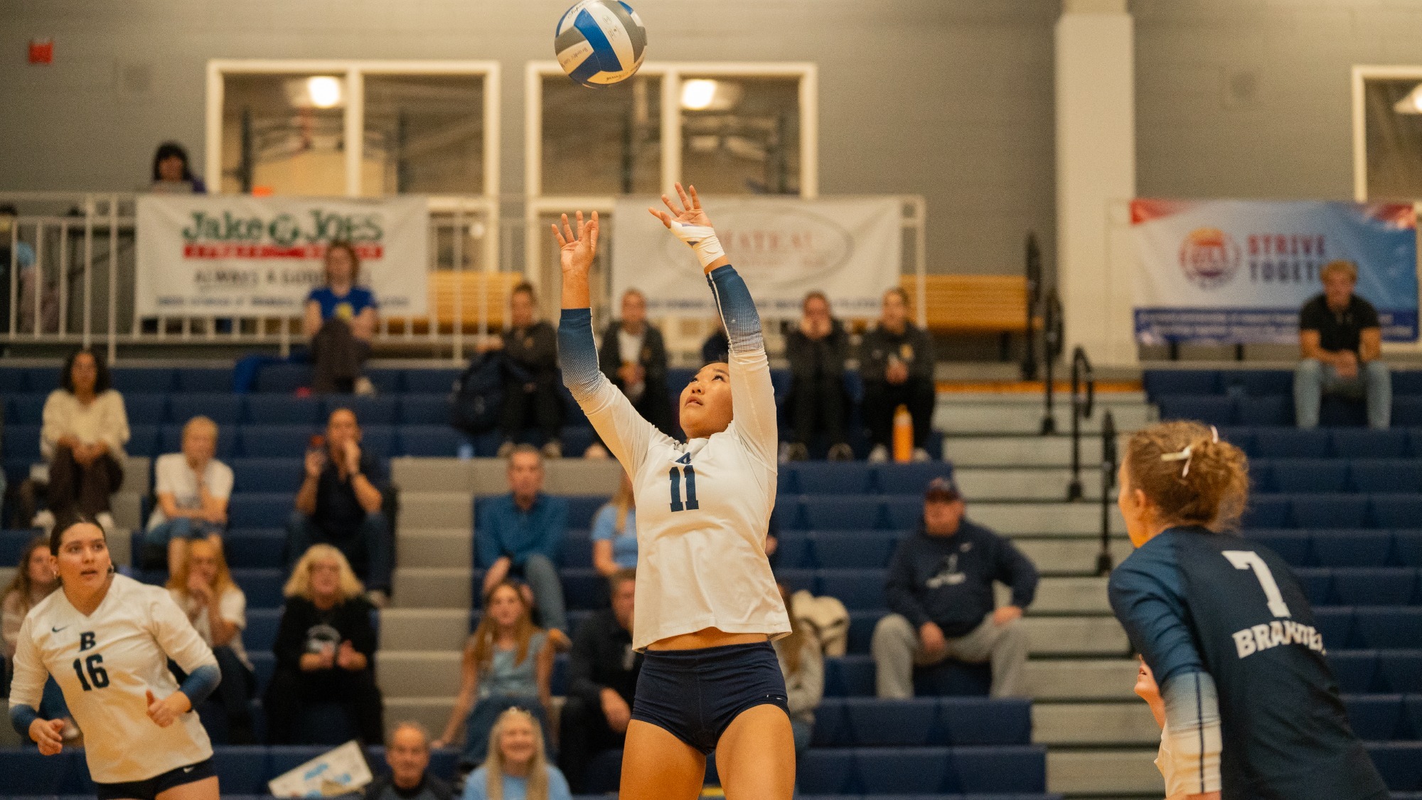 Alexa Ho sets a volleyball during a match