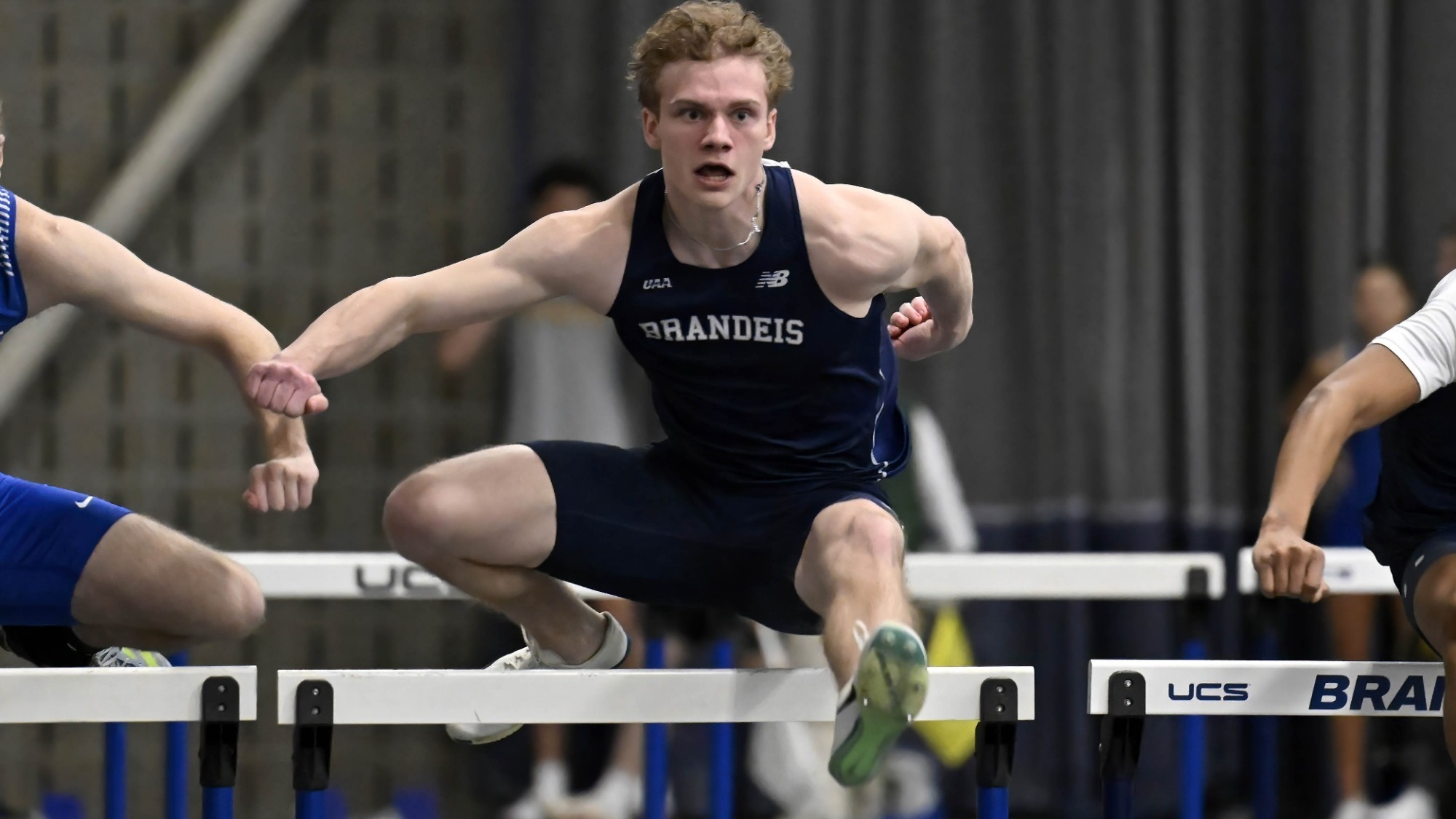 Eli Wawersik leaping over a hurdle during a race