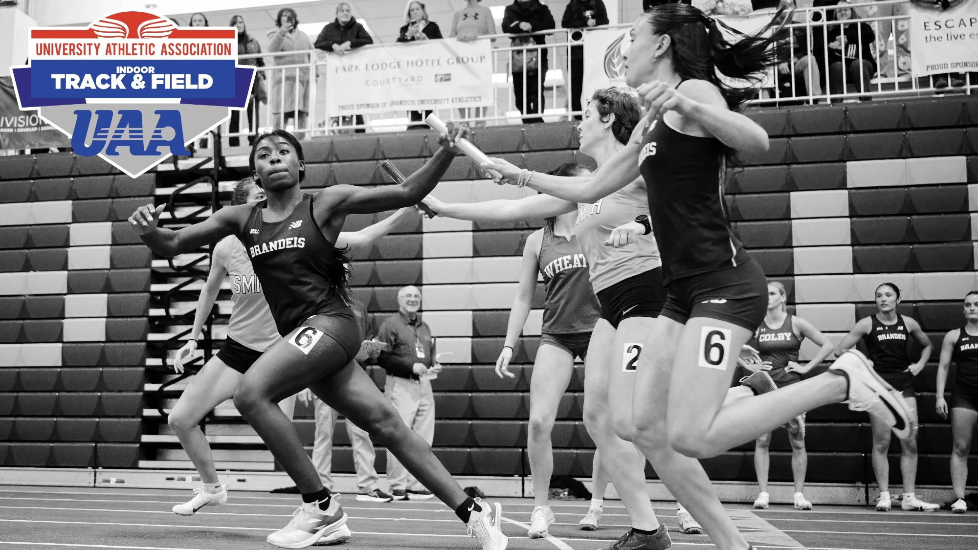 Black and white photo of Brandeis track athletes handing off a relay baton; UAA Track and Field logo in the upper-left corner