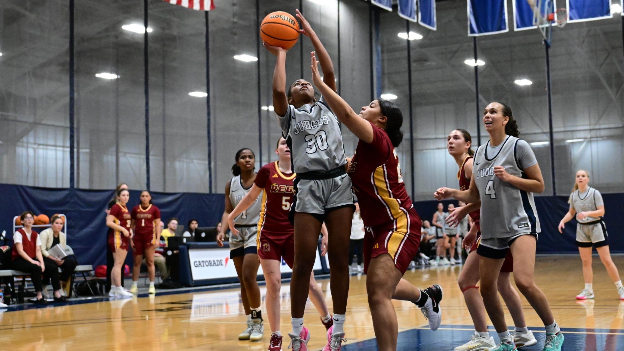 Saviah Shabazz goes up for a shot between two defenders during a basketball game