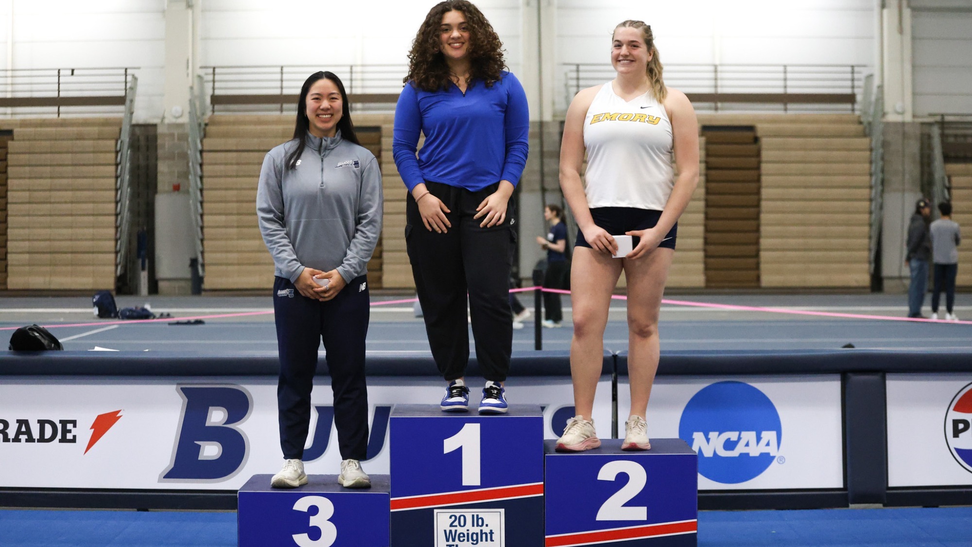 Emma Liu on the podium for her All-UAA performance in the 20-pound weight throw
