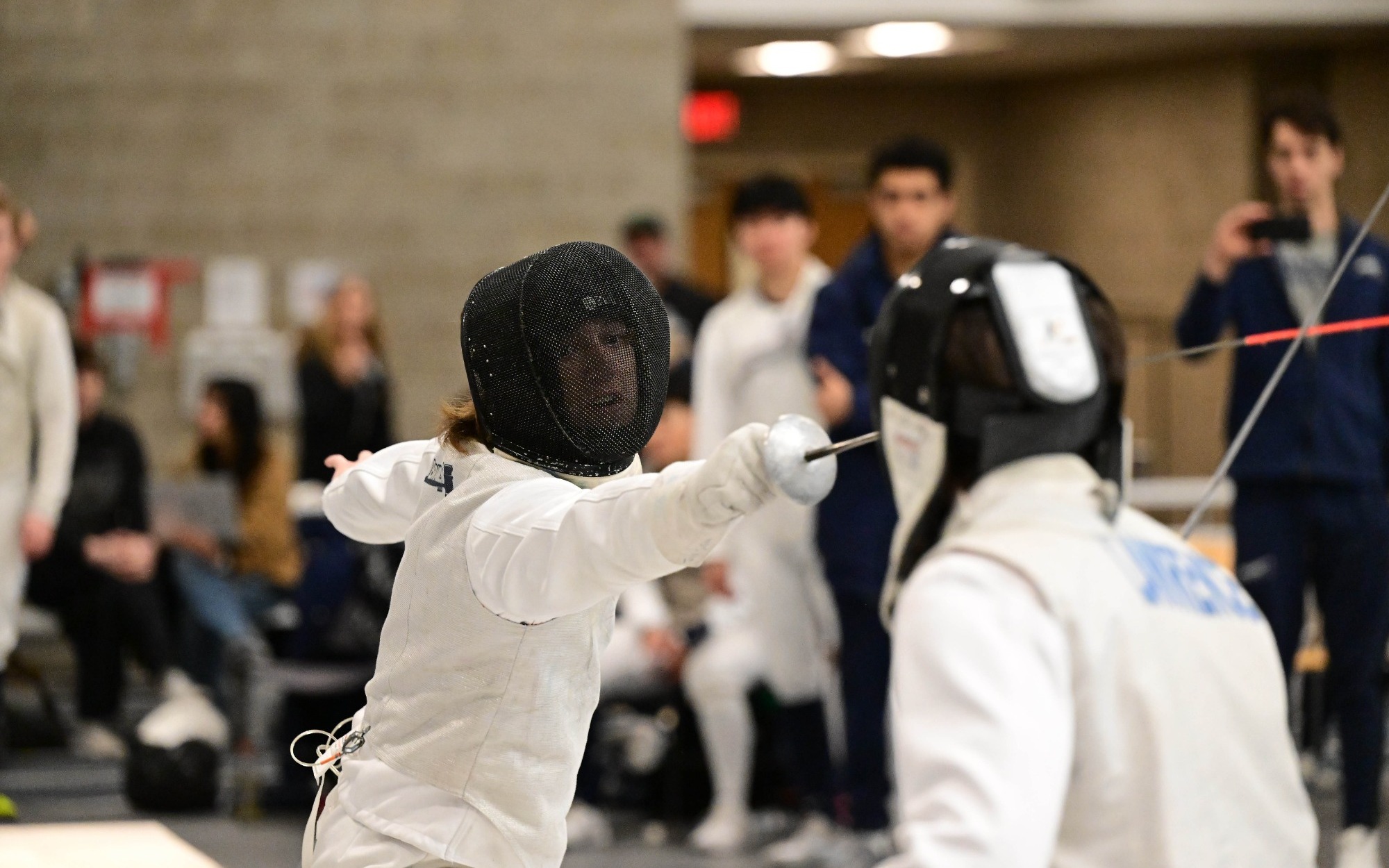 Jackson Sullivan attacks with his foil during a fencing match