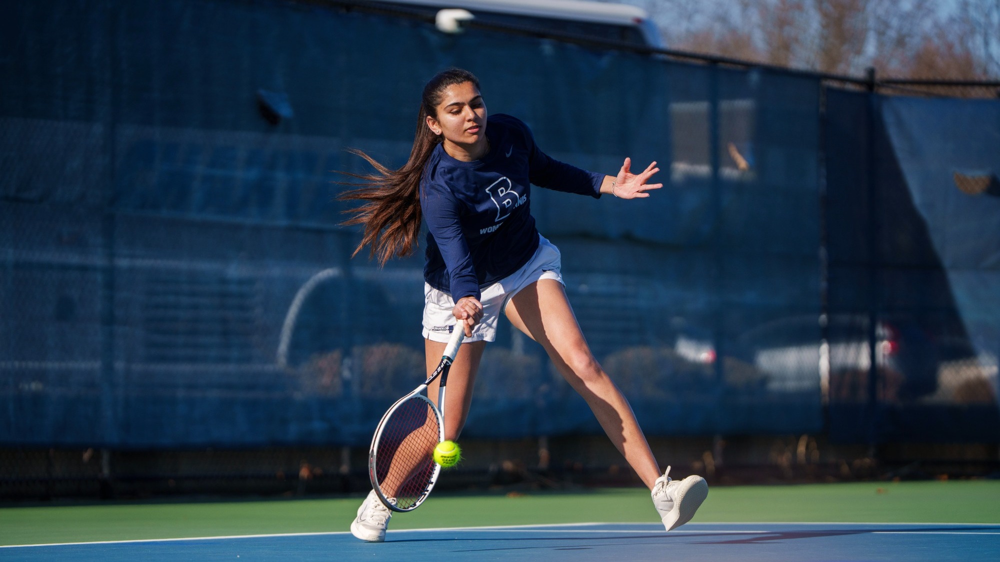 Chahana Budhbhatti hits a forehand during a tennis match