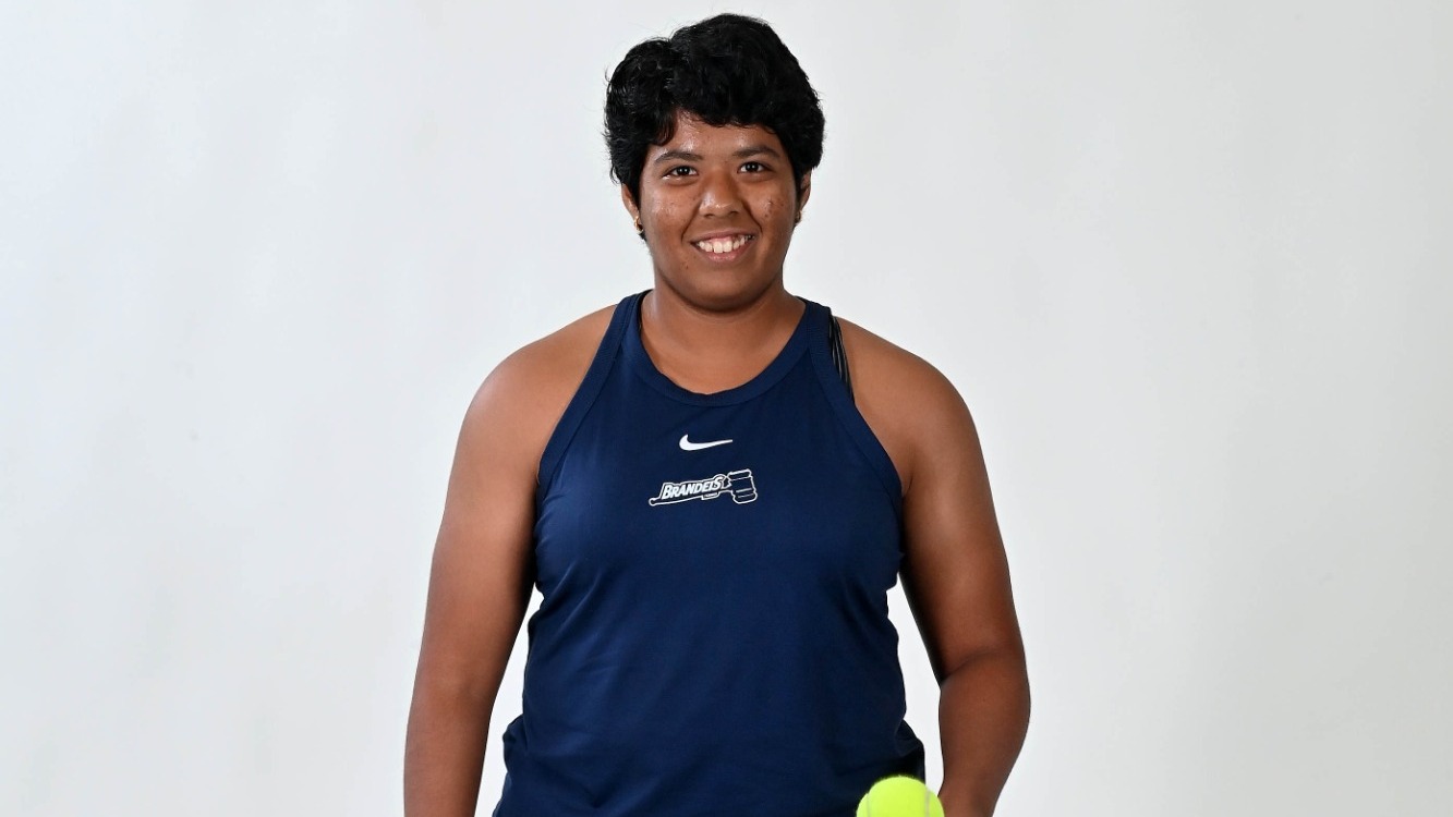 Avani Chitale poses for the camera, bouncing a ball on her racquet