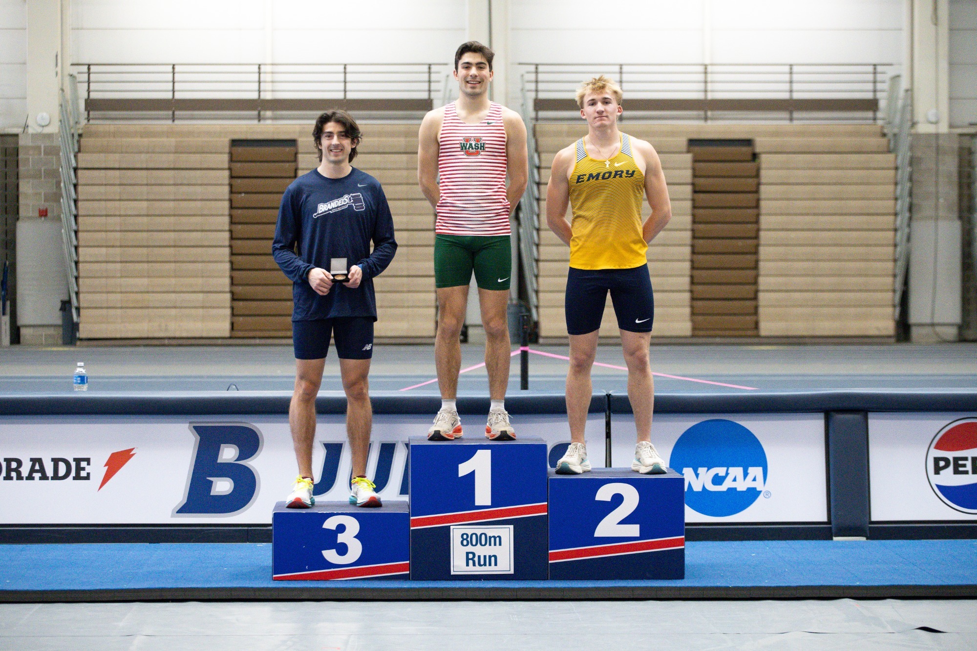 Garret Rieden stands on the podium with his bronze medallion for finishing third in the 800m run