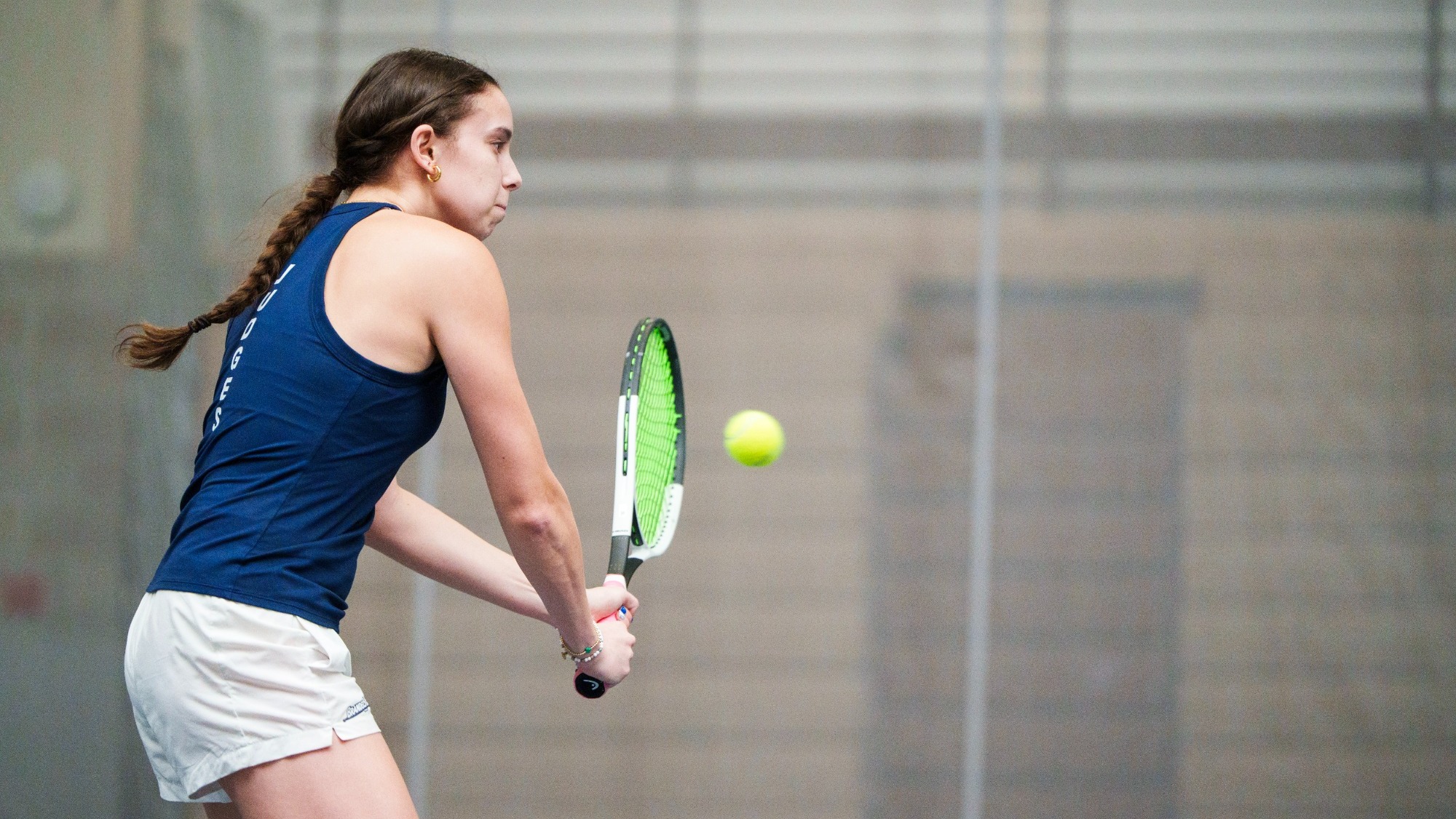 Charly Saltz hitting a backhand during a tennis match