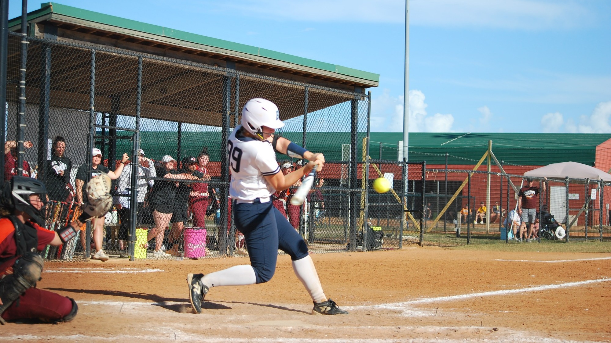 Jordan Wallace swinging at a pitch during a softball game