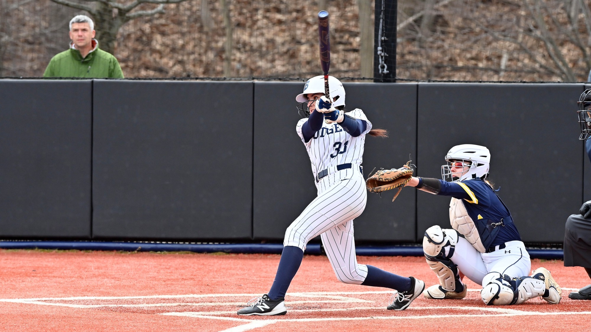 Bells Burdenski swings at a pitch during a softball game