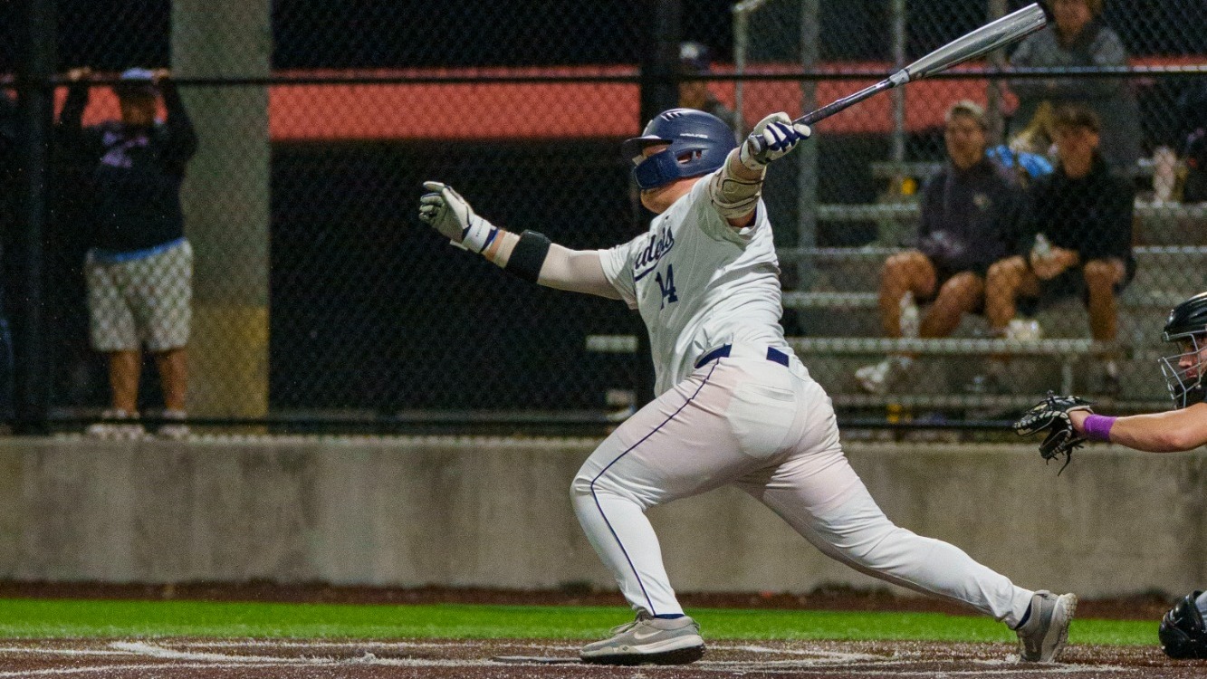 Keith Lee folows through on a swing at a pitch during a baseball game