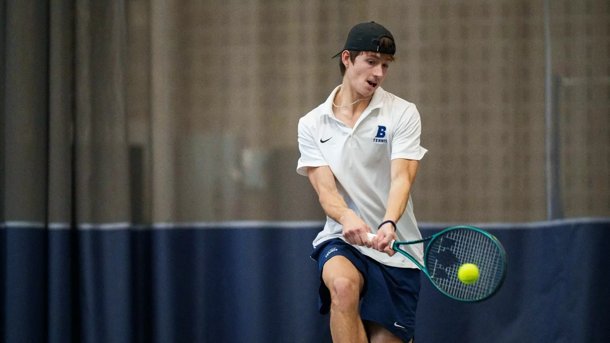 Oliver Lorenz hits a two-handed backhand during a tennis match