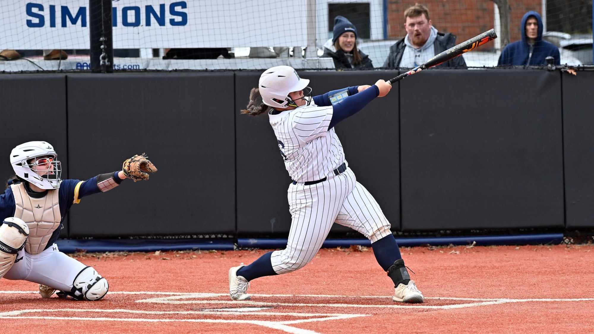 Dylan Yamamura follows through on a swing during a softball game