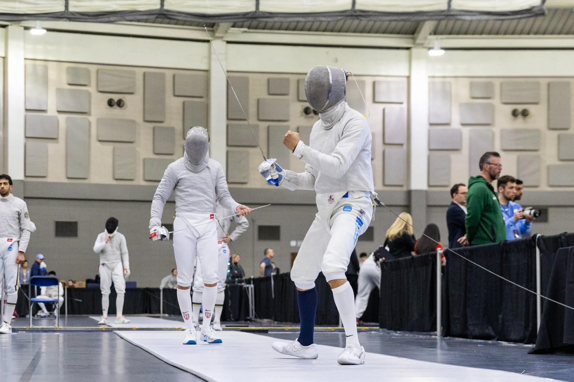 Lev BenAvram (left) pumps his fist after winning a point during the NCAA Fencing Championships