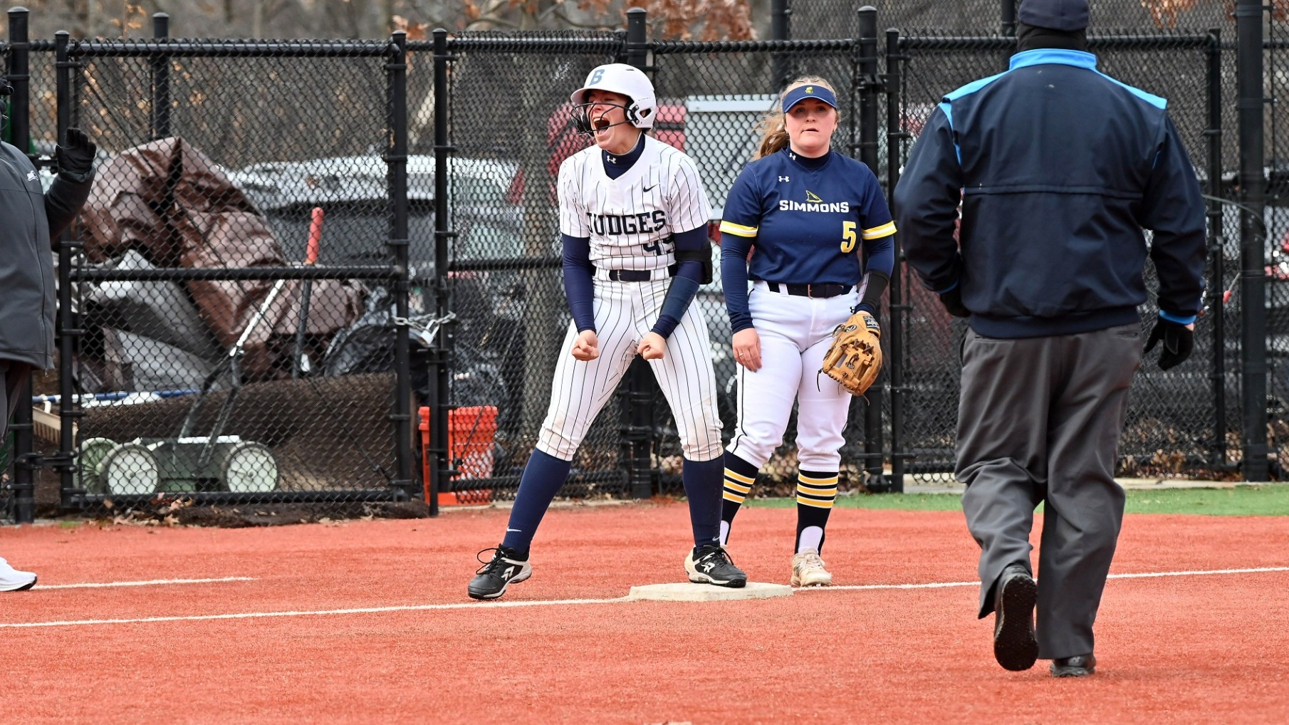 Jordan Wallace stands on third base, shouting in excitement, during a softball game