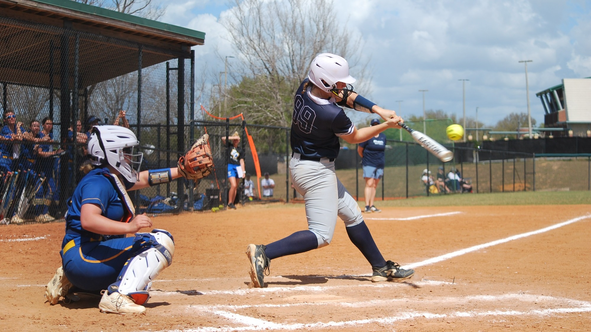Jordan Wallace swinging at a pitch during a softball game