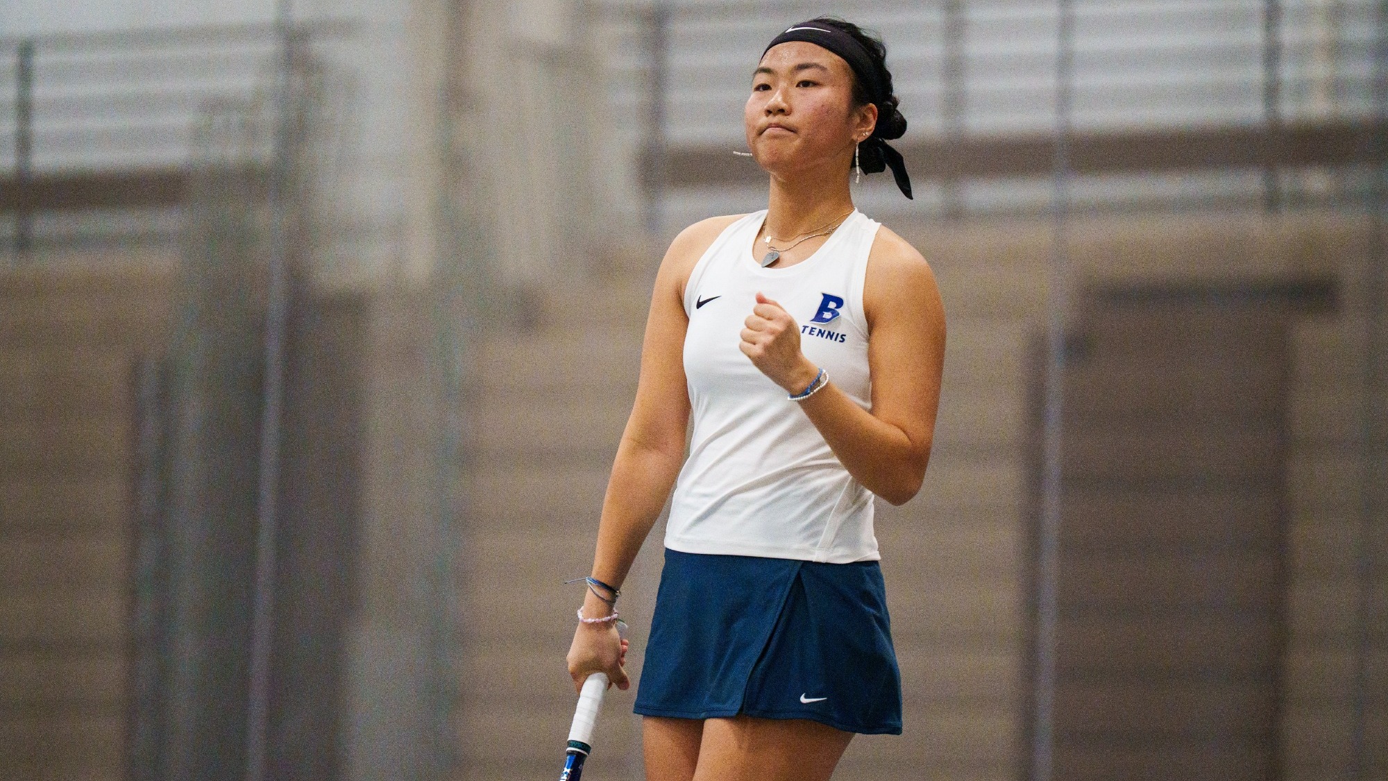 Nancy Zhang pumping her fist after winning a point during a tennis match