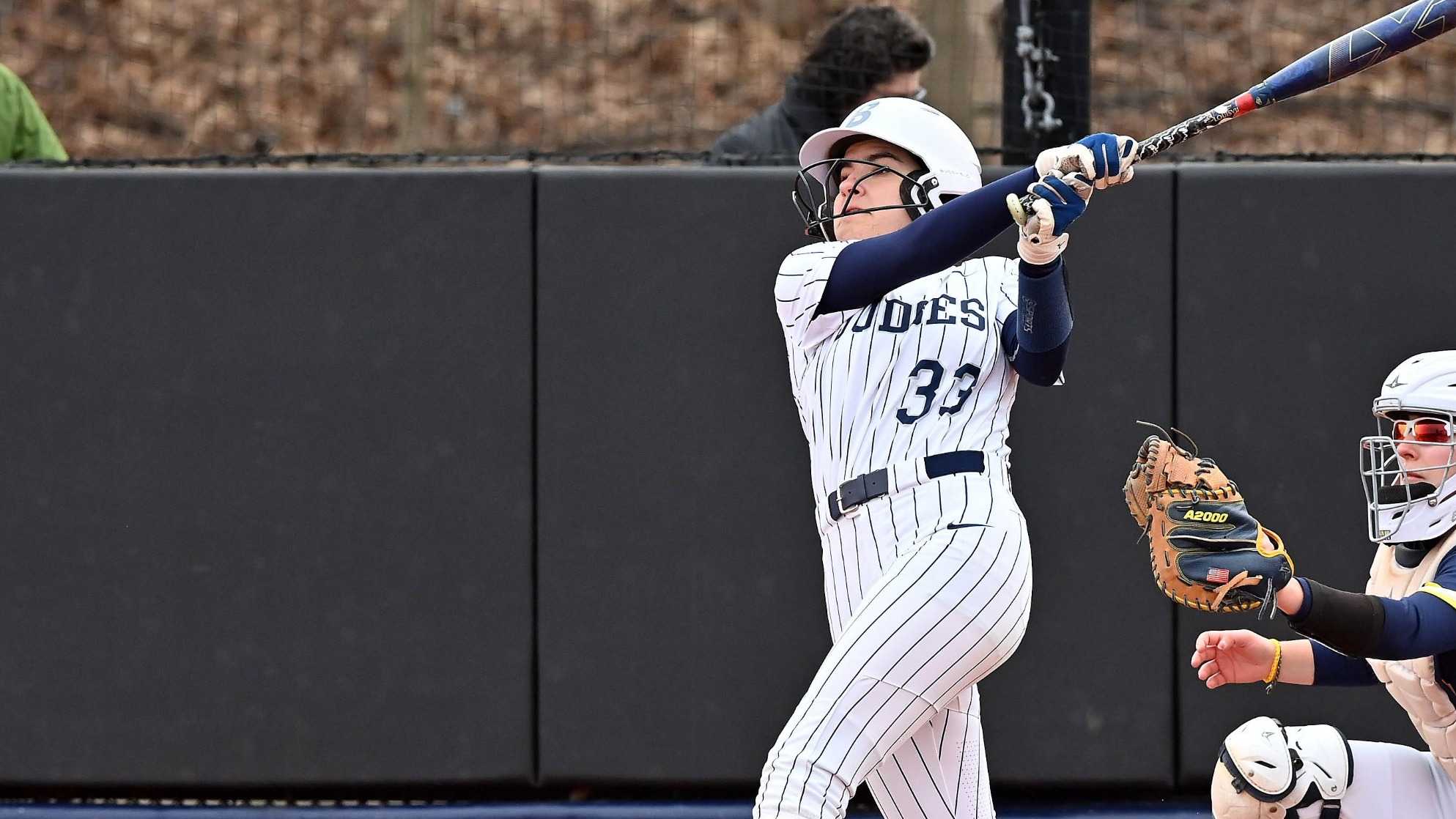 Bells Burdenski follows through with a swing during a softball game