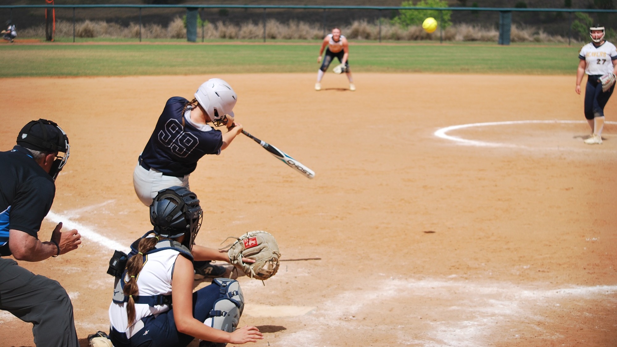 Jordan Wallace hits a ball during a softball game