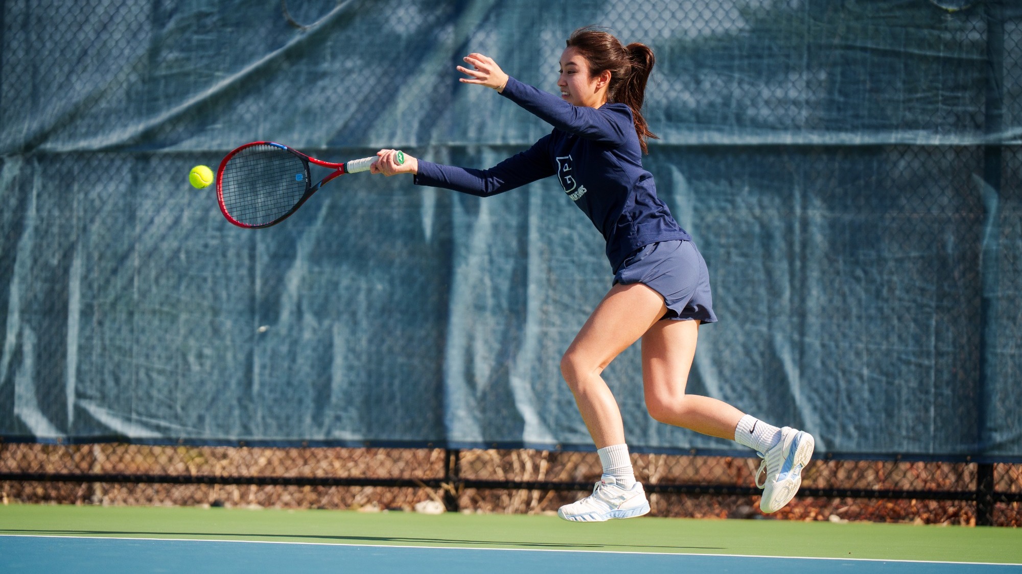 Mandy Reyes makes a return shot during a tennis match