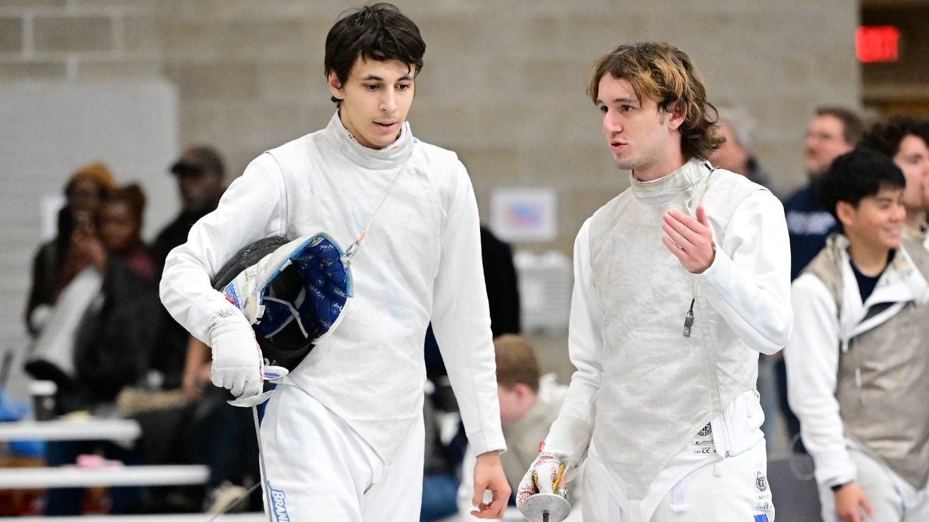 David Knizhnik discusses strategy with a teammate during a fencing bout