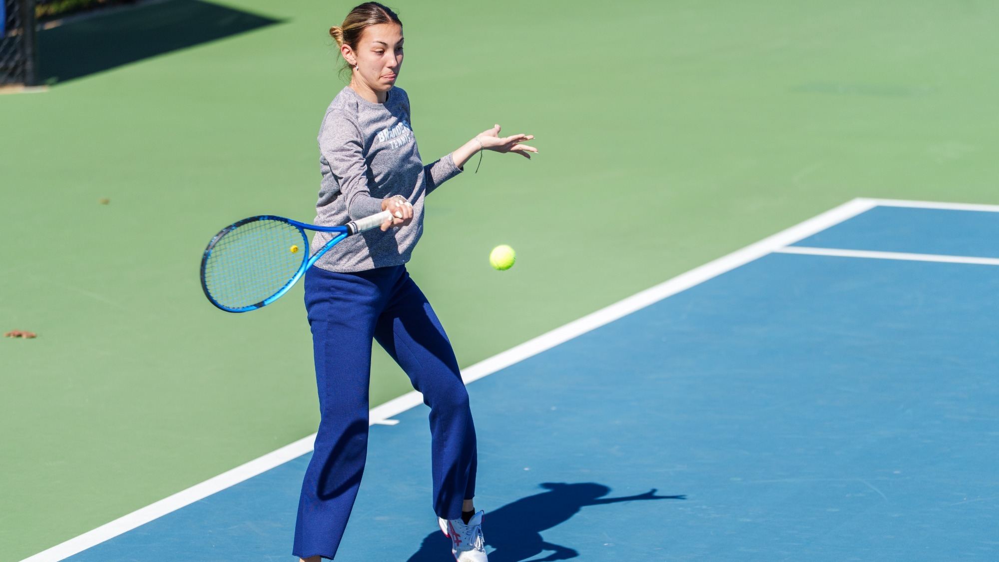 Milana Sofizade hits a forehand return during a tennis match