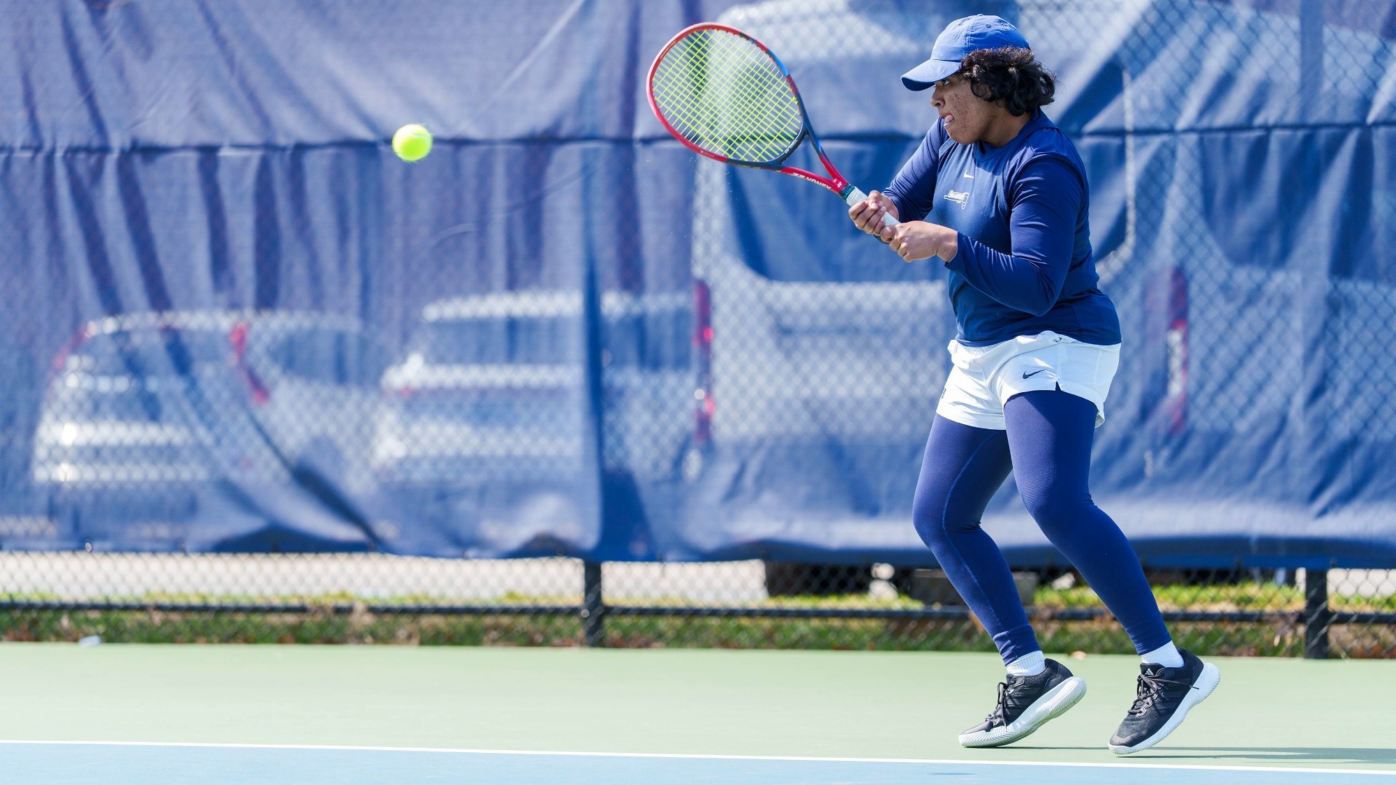 Avani Chitale hitting a return during a tennis match