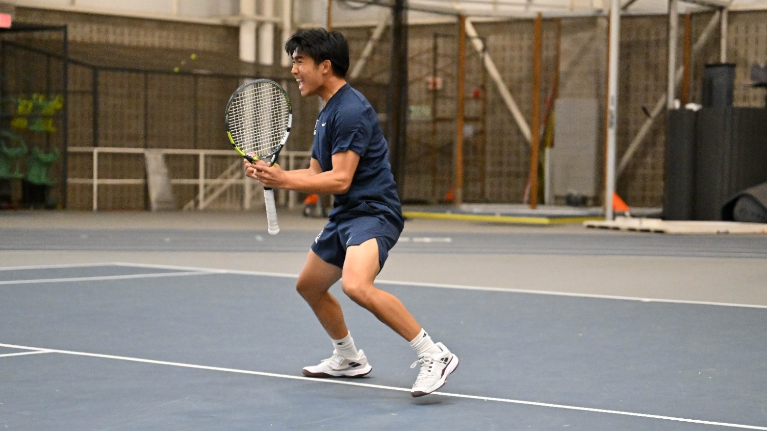 Aidan Wang-Fan celebrates winning a point during a tennis match