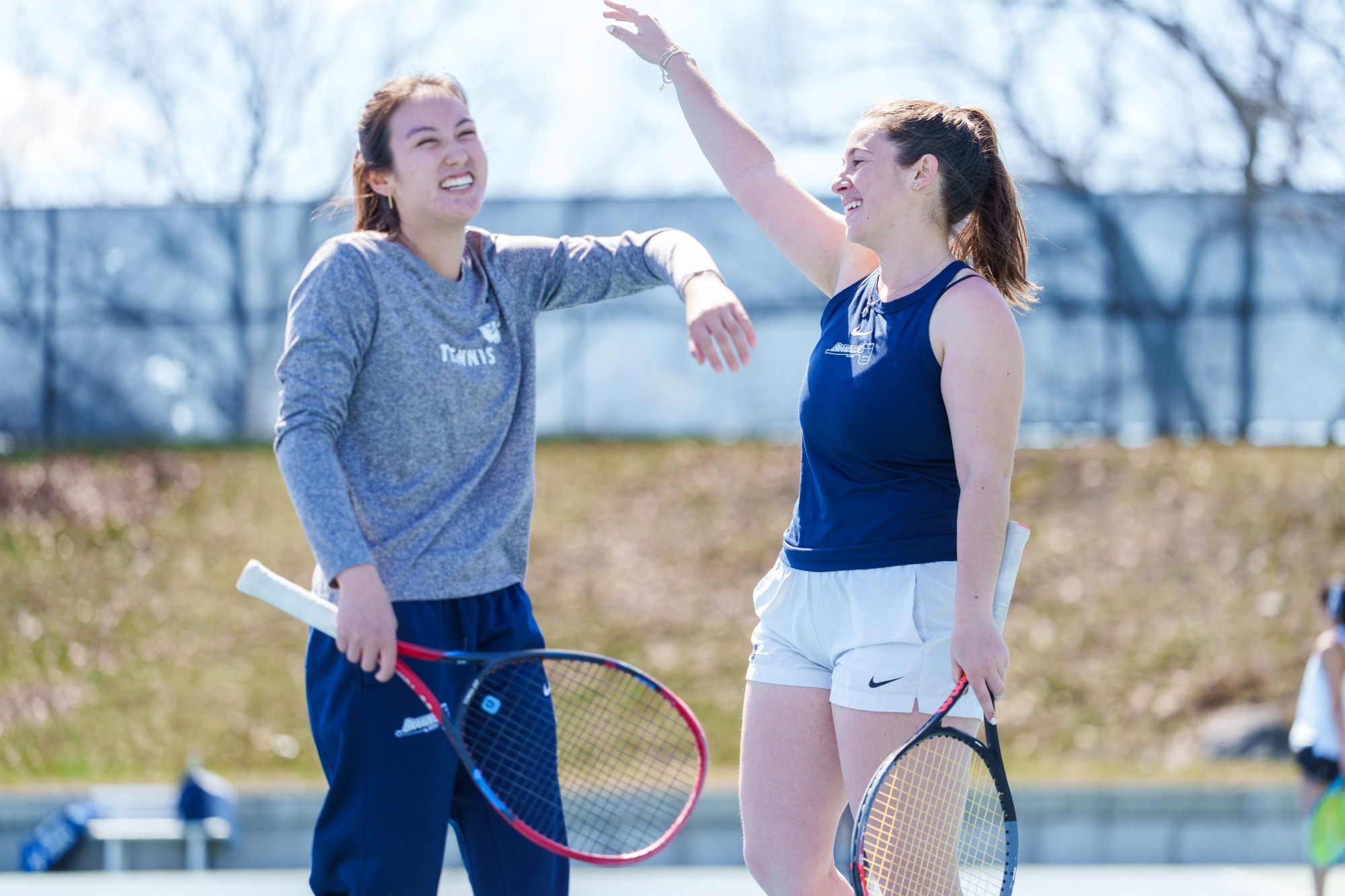 Mandy Reyes and Rebecca Suarez acting silly for the camera before a tennis match