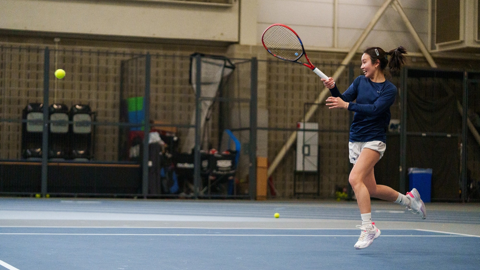 Mandy Reyes hits a return during a tennis match