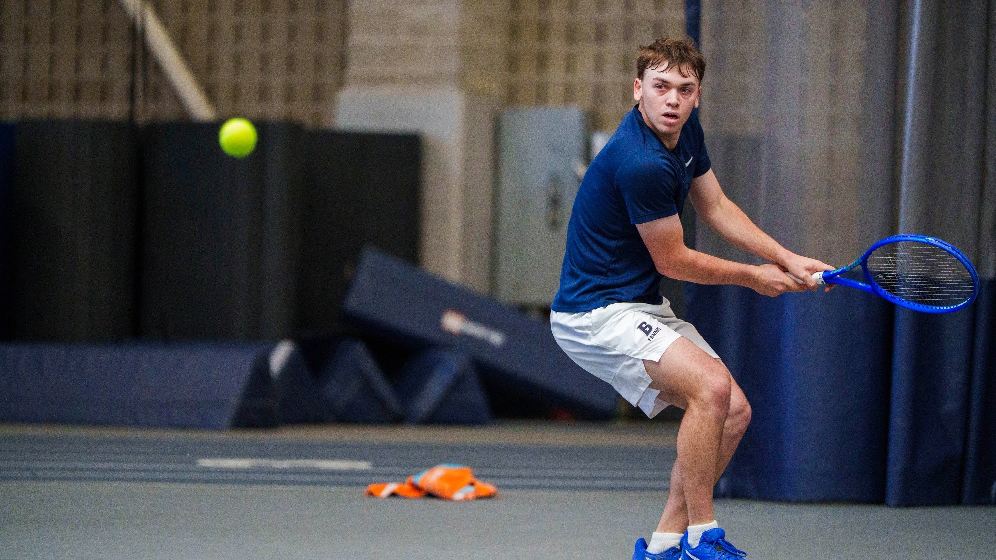 Pierce Garbett prepares to hit a backhand return in a tennis match