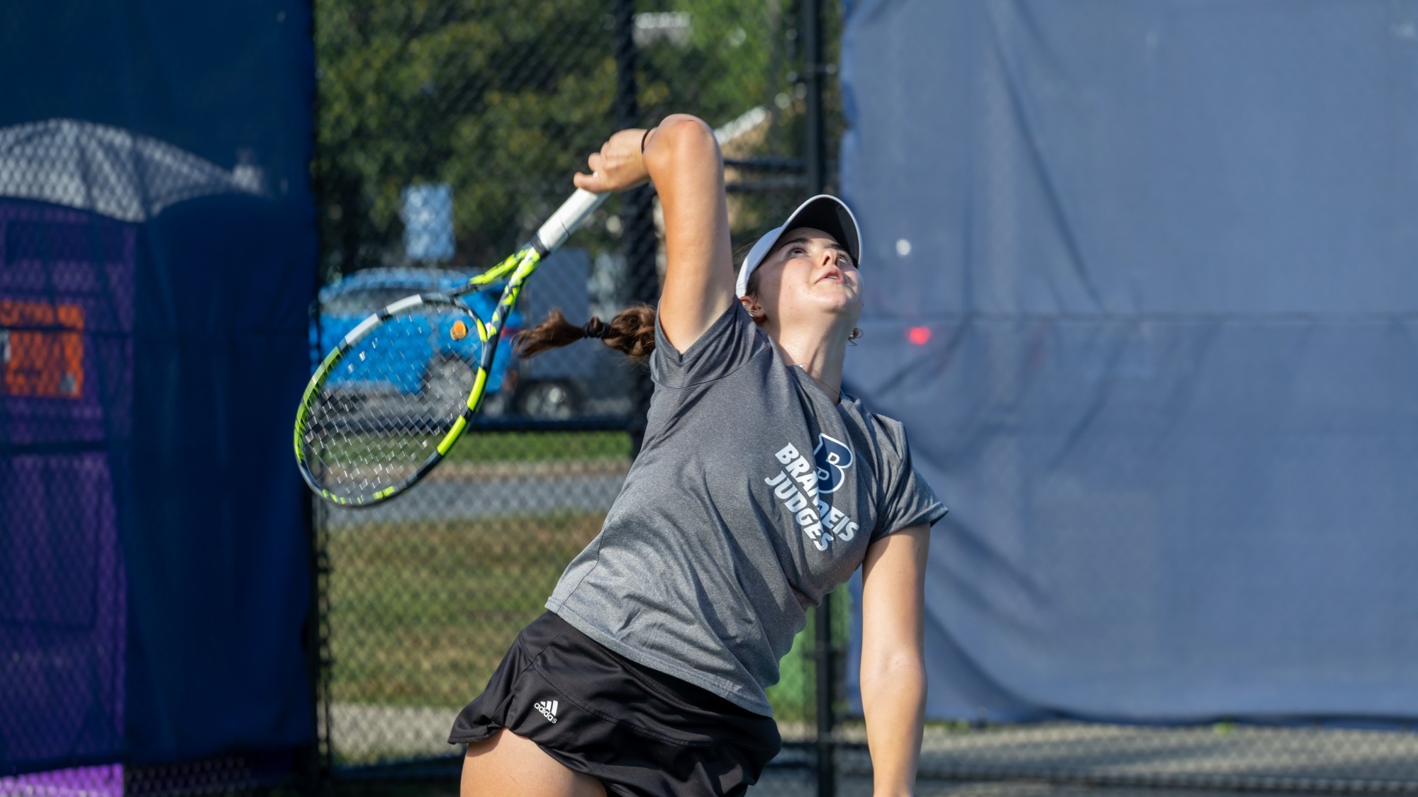 Elli Gerontikou serves a tennis ball