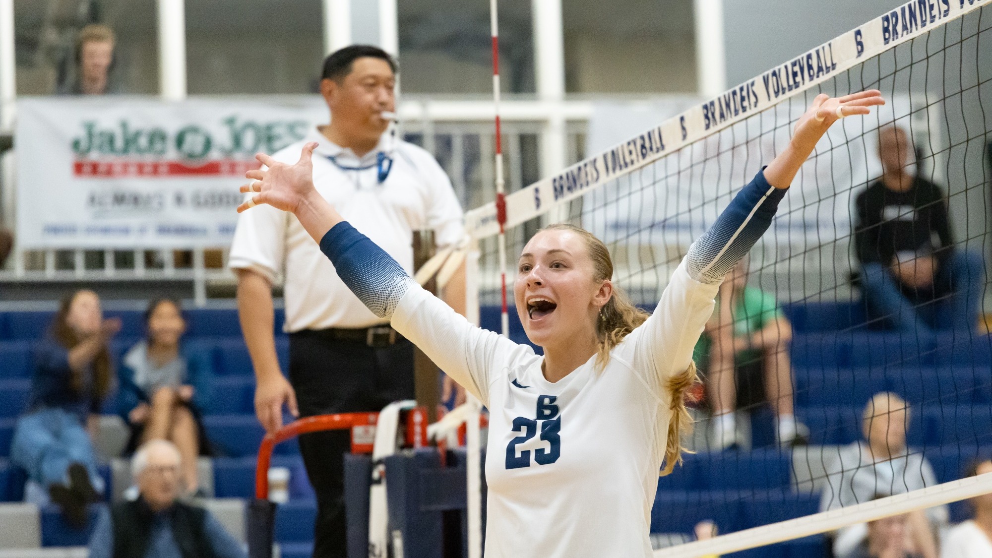 Madison Haft-Abromovitch with arms raised in celebration after winning a point in a volleyball match