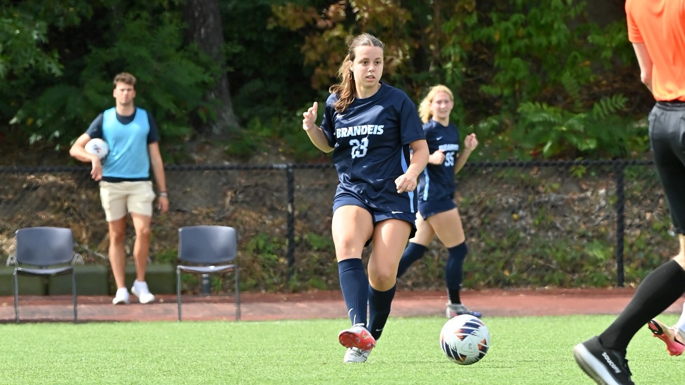 Grace Carman passes a soccer ball during a match