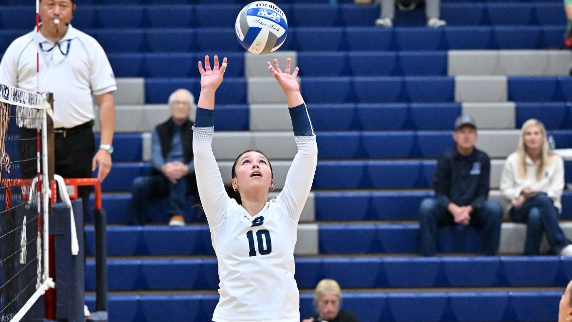 Camila Valenzuela sets a volleyball during a match