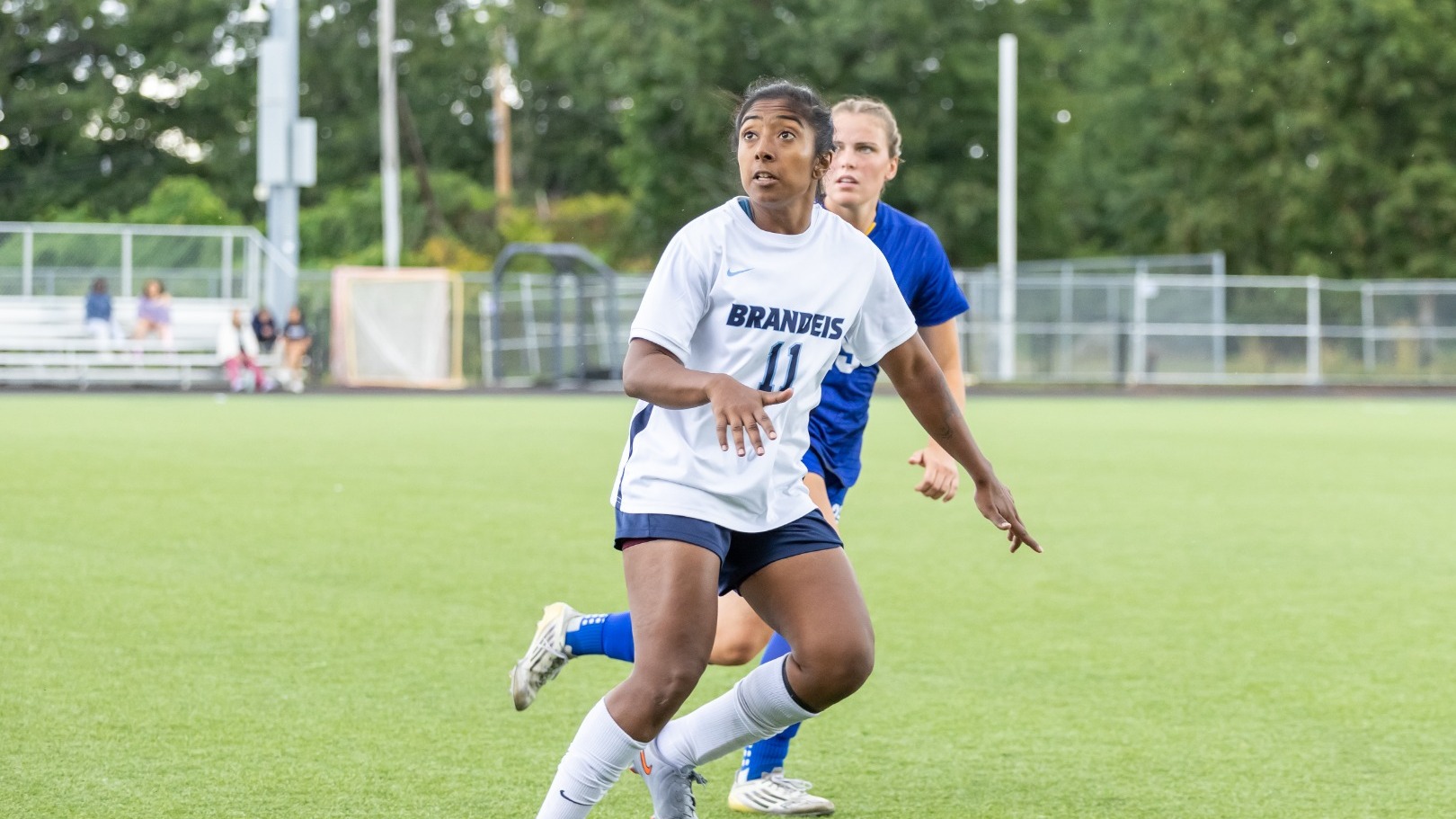 Tanvi Raju looks up with a defender on her back during a women's soccer match