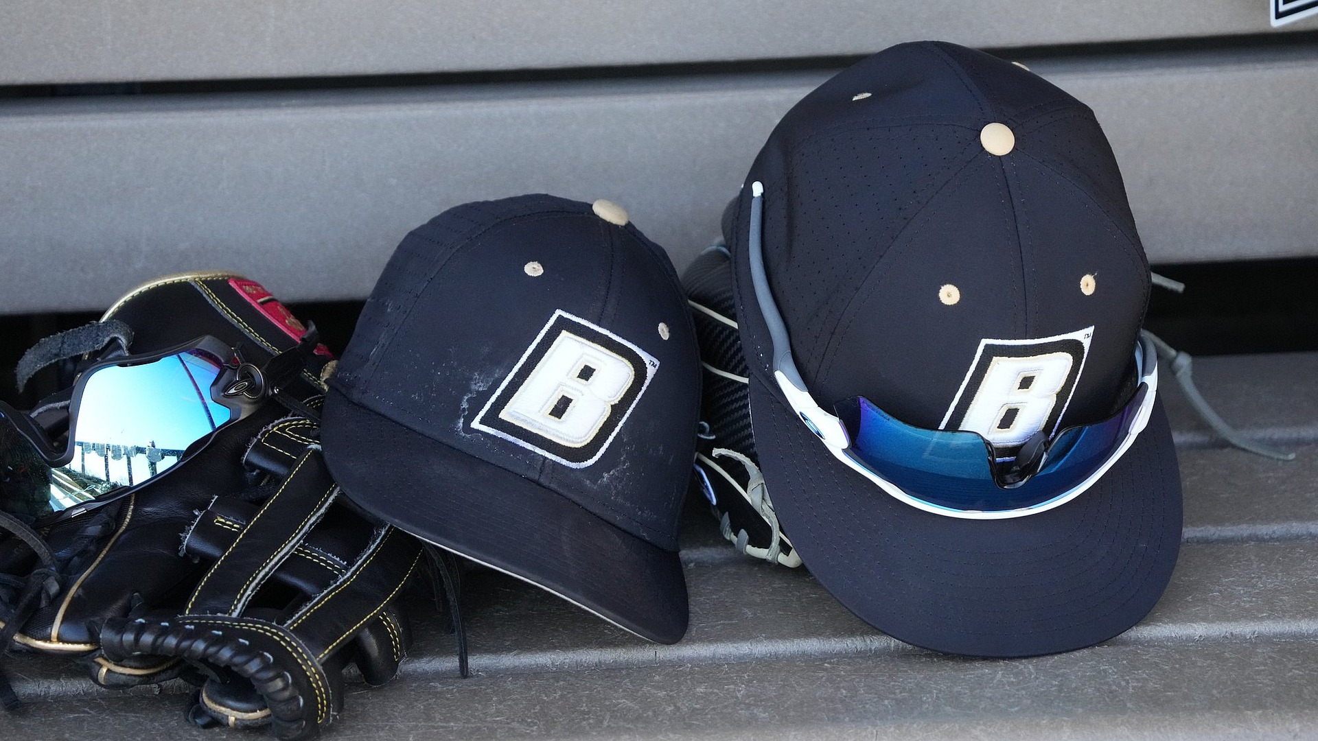 Picture of Baseball Hat with sunglasses on a bench