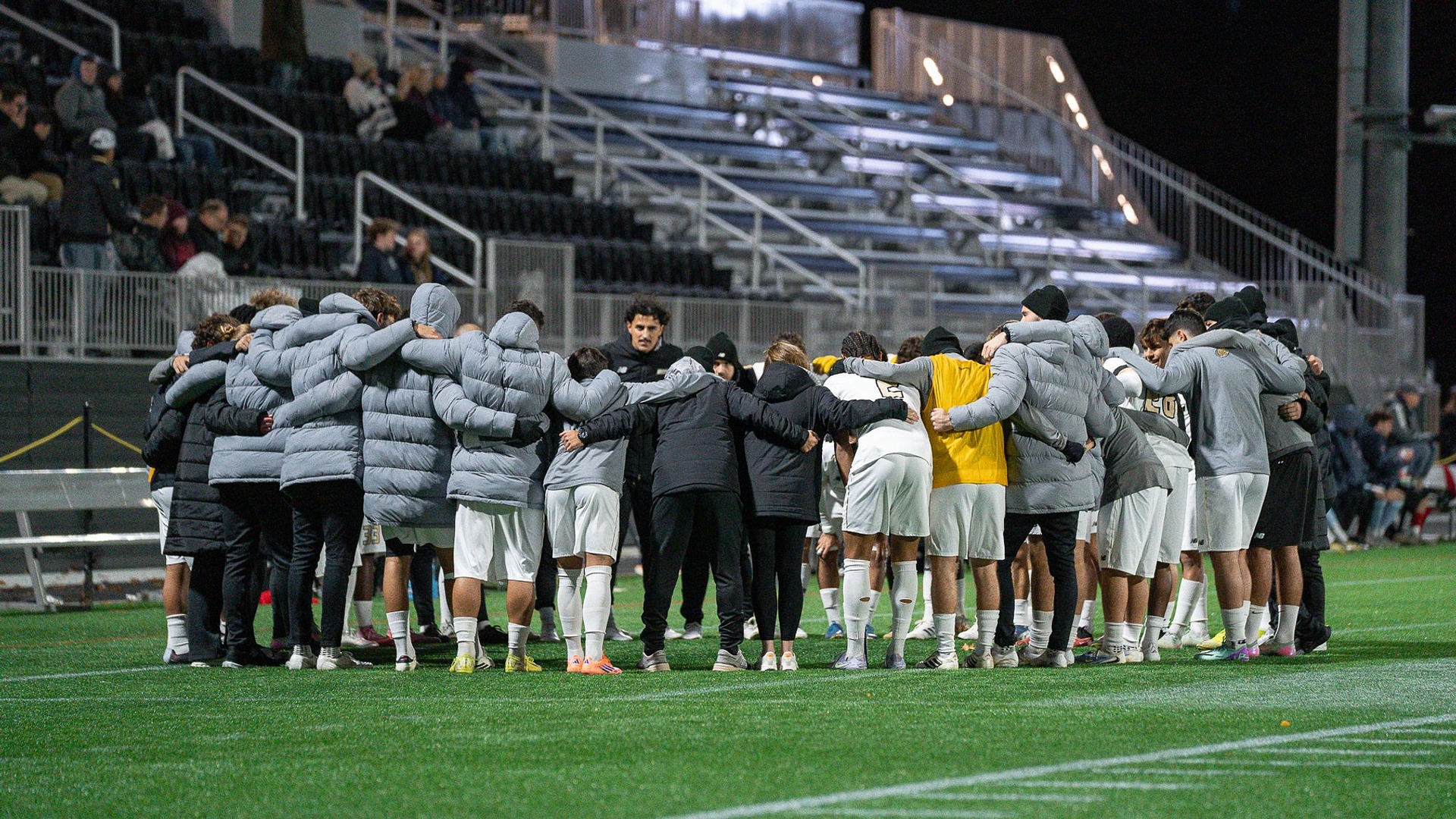 Men's Soccer team huddle ahead of the upcoming match