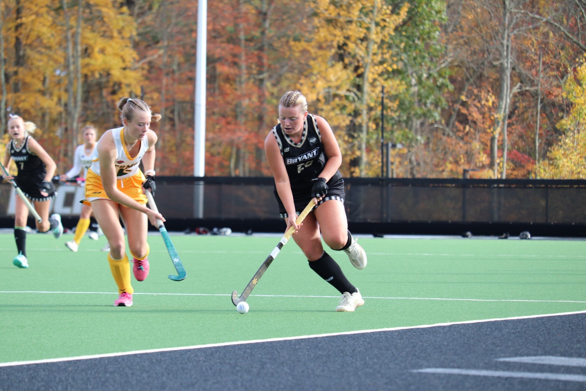 Callie Caito Carries the Ball upfield with a Vermont defender