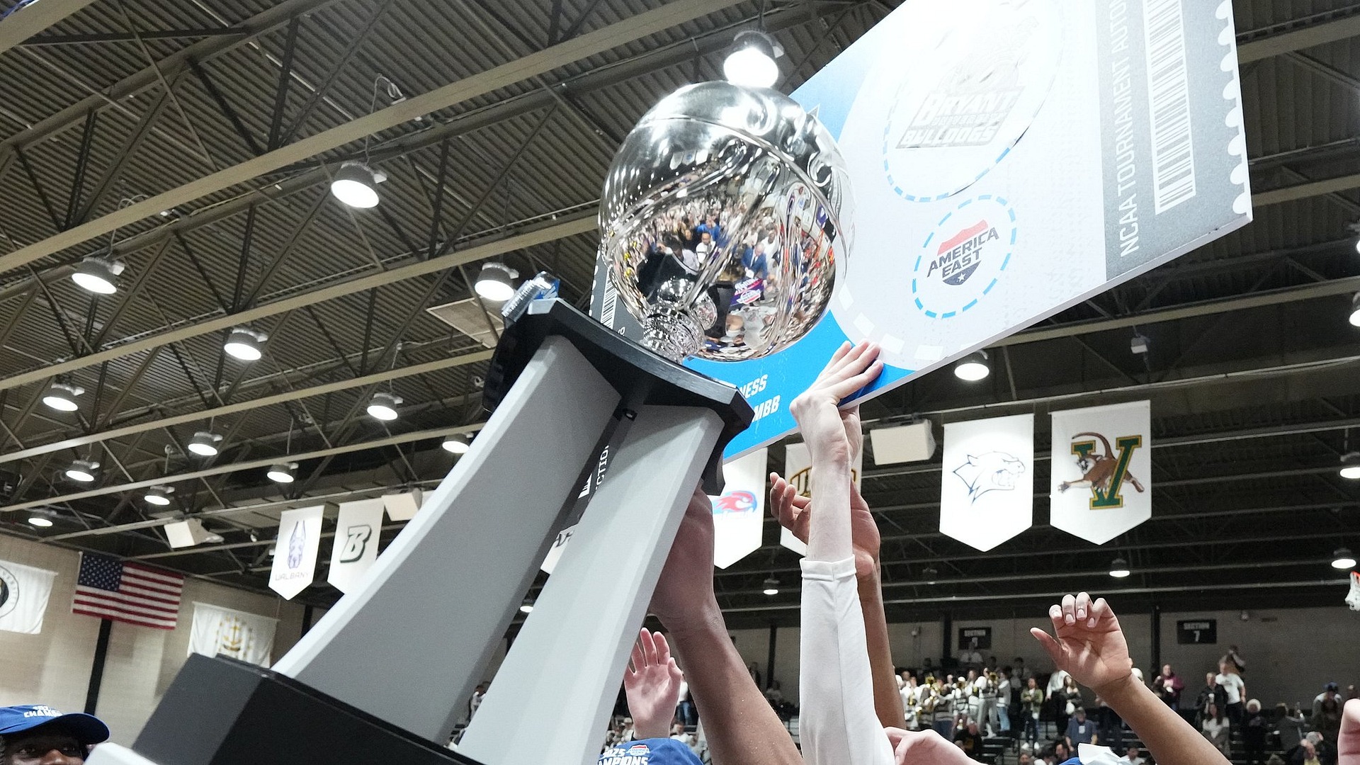 America East Basketball Trophy Being Held Up