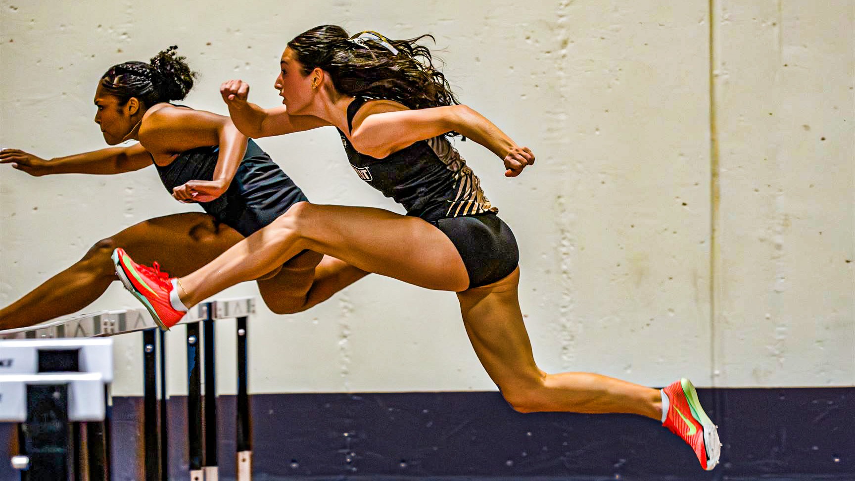 Madison Guerrera jumping over the hurdle