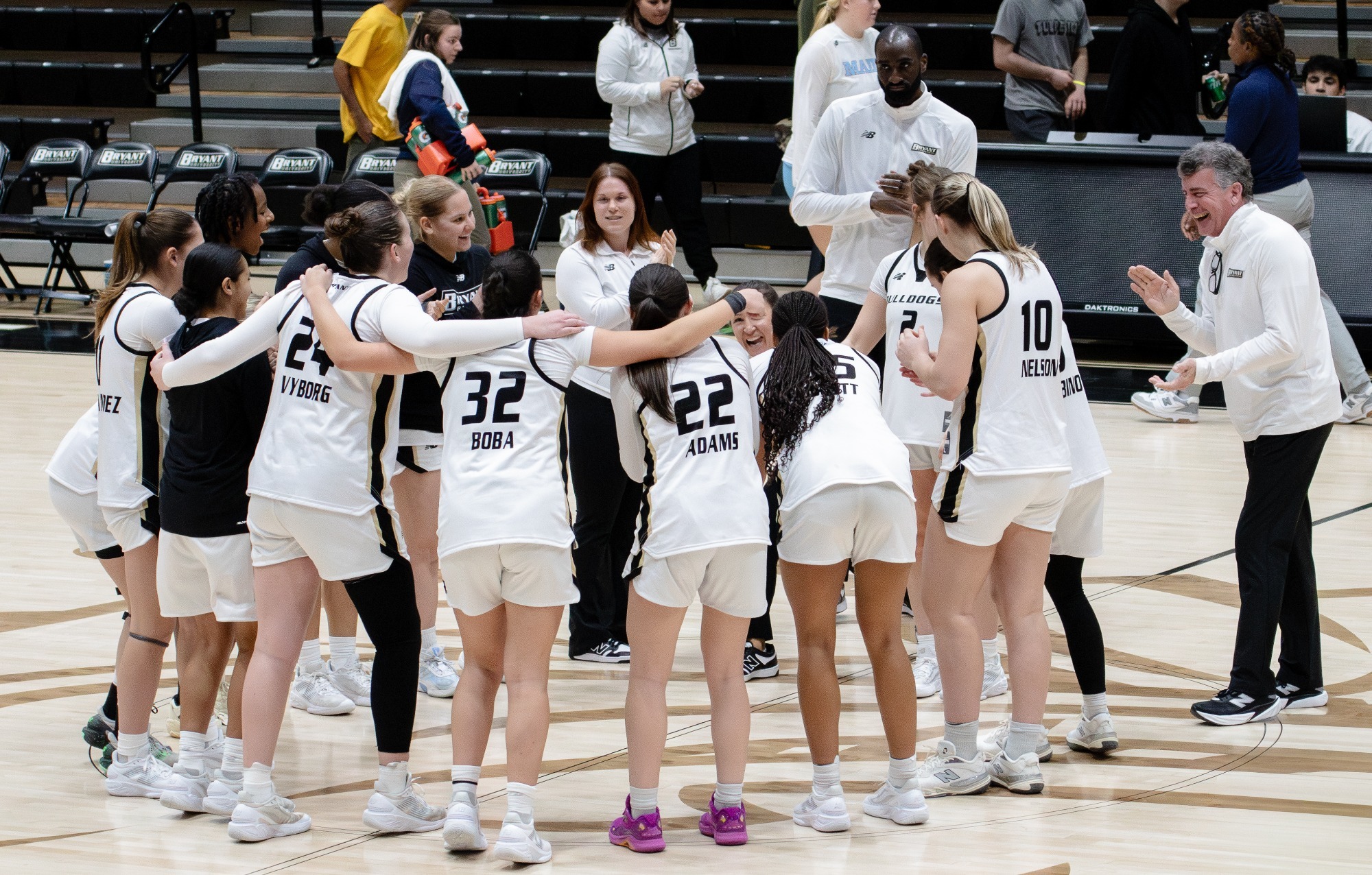 WBB Team Huddles at Midcourt following win over Maine