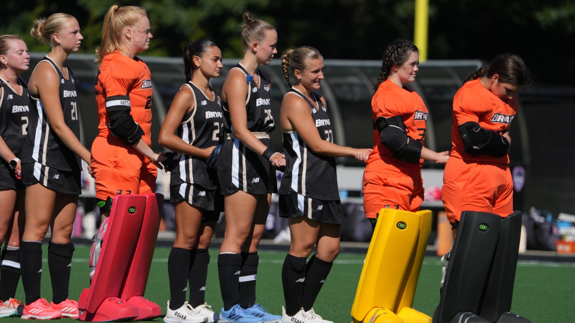 Field Hockey players lineup for the national anthem