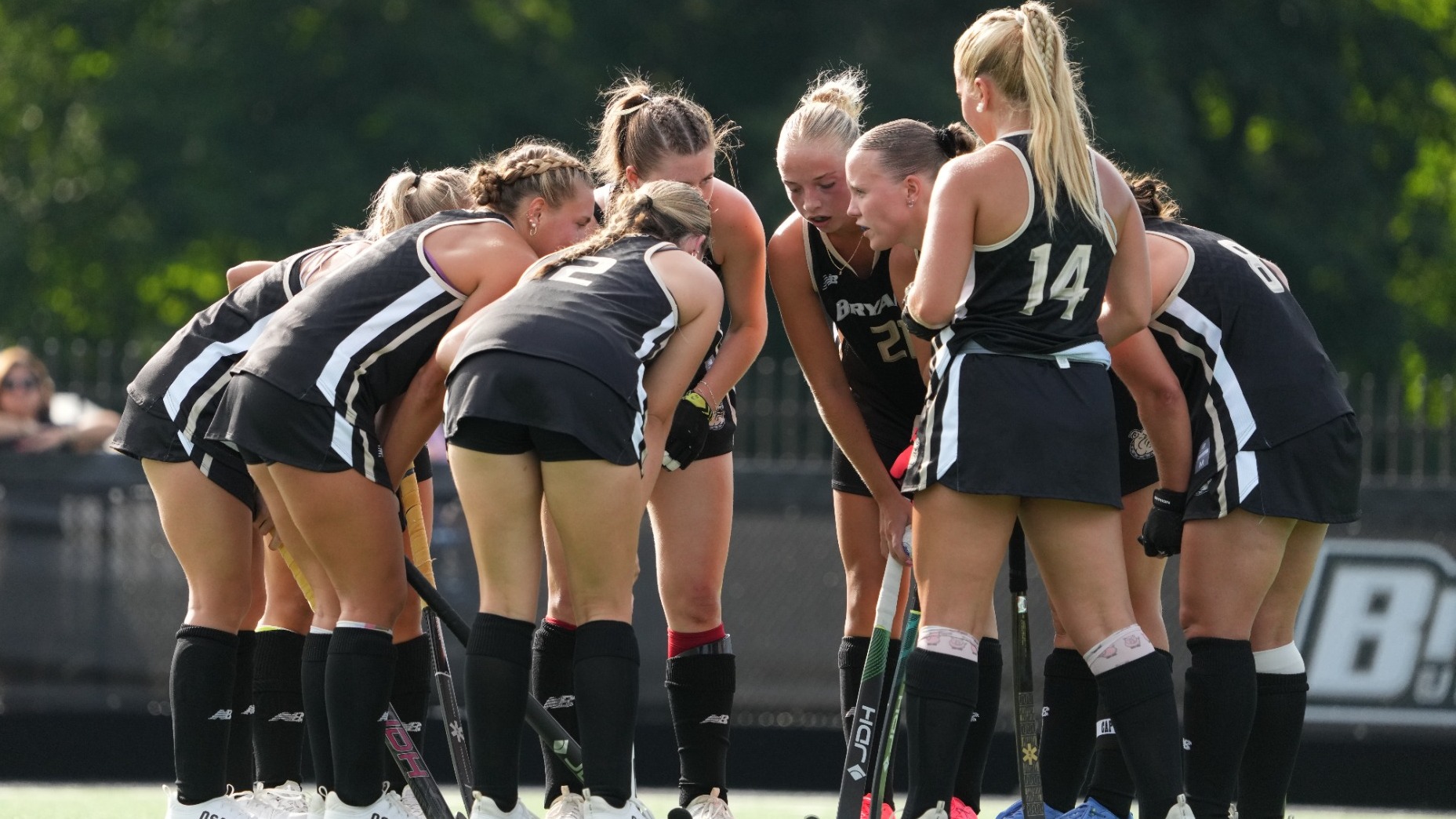 Field Hockey team huddles vs Merrimack