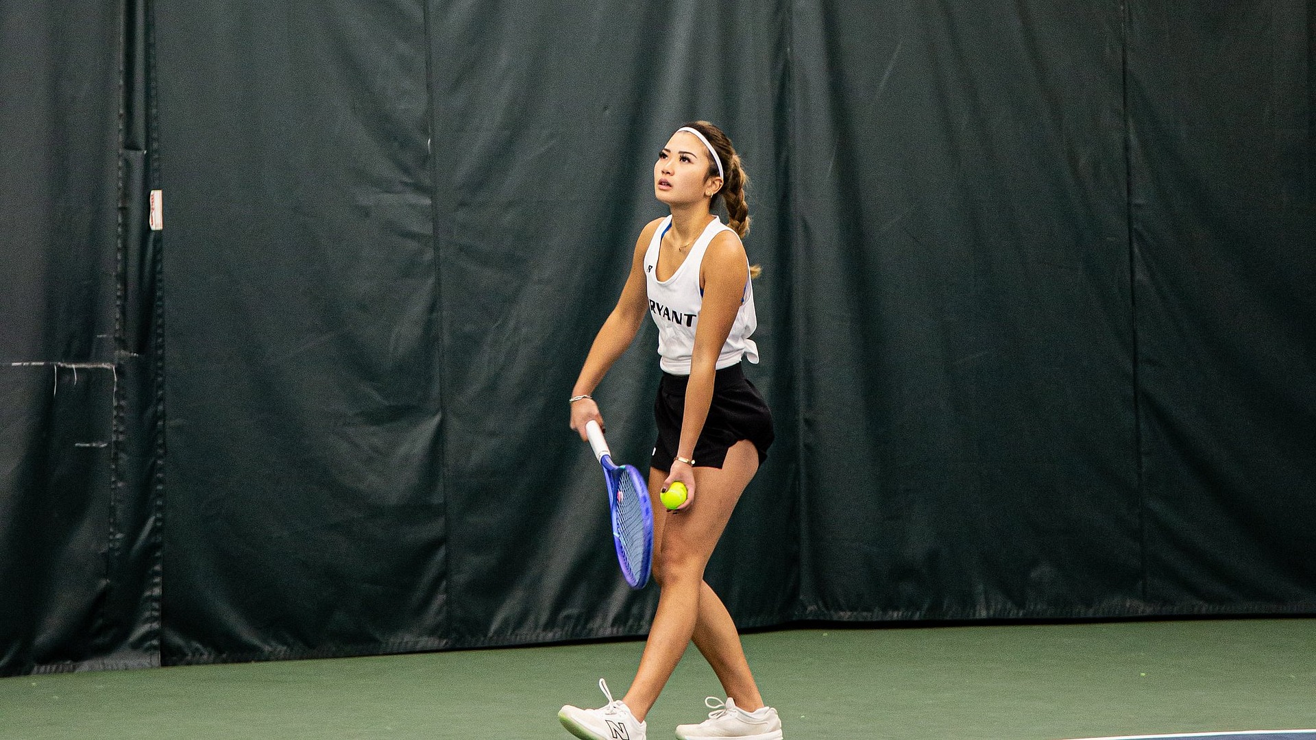 Nicole Isman preparing to toss up ball to serve 