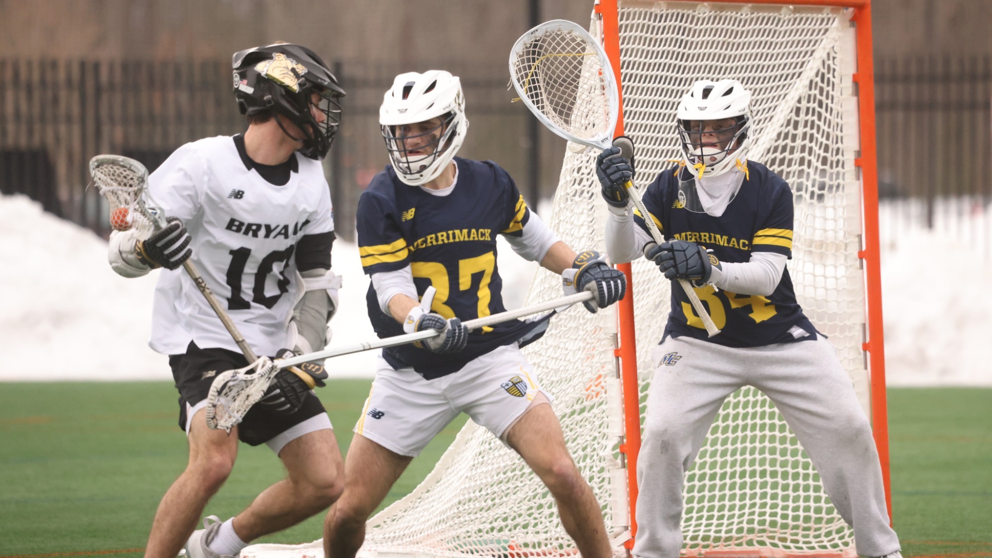 Zac Amend trying to score a goal against a defender and a keeper