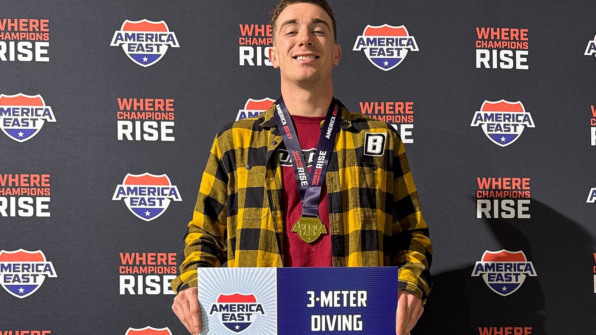 Chris Buonocore Gold Medal Picture holding 3 meter dive sign