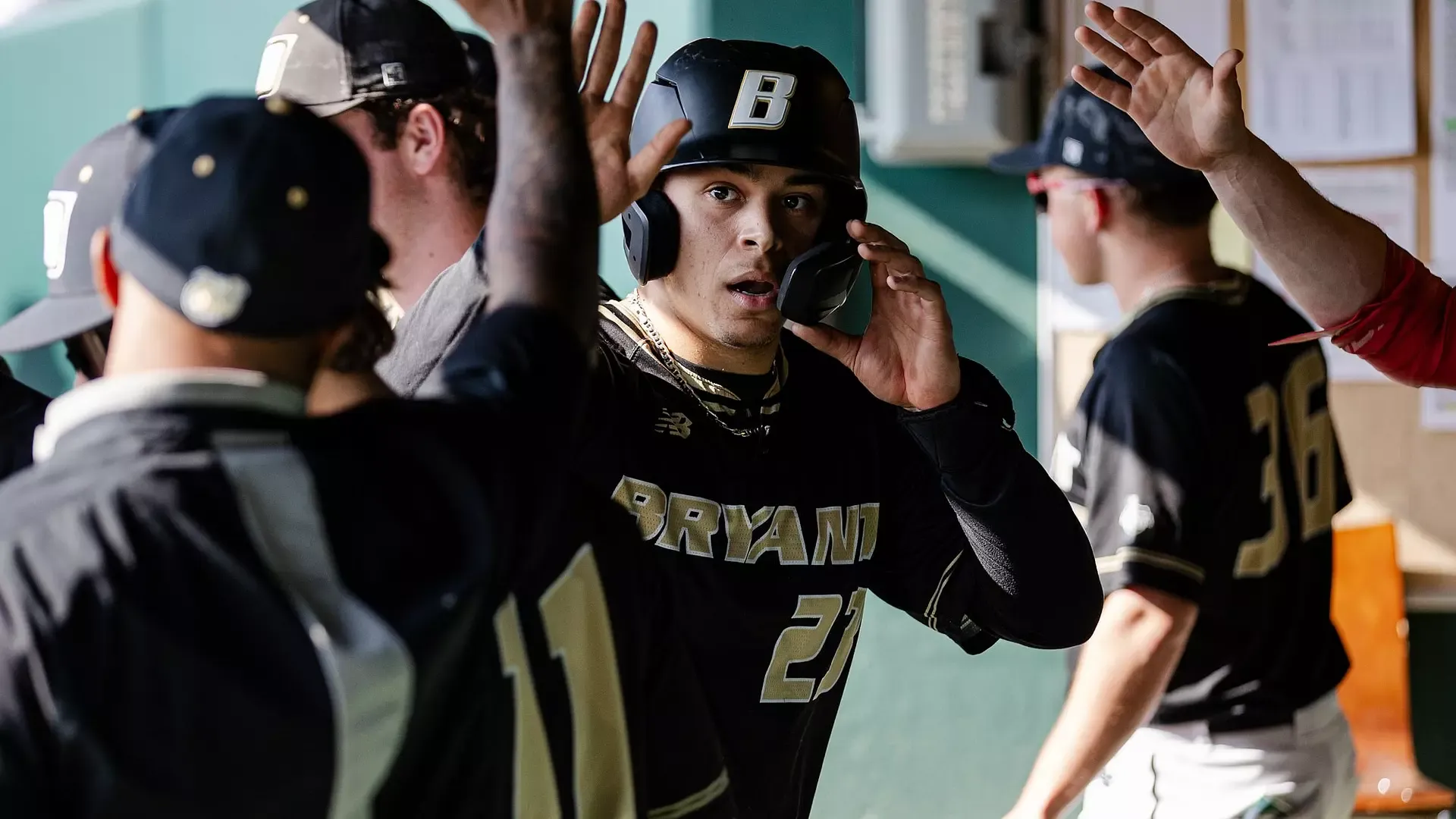 Ellis Garcia High Fives teammates in the dugout