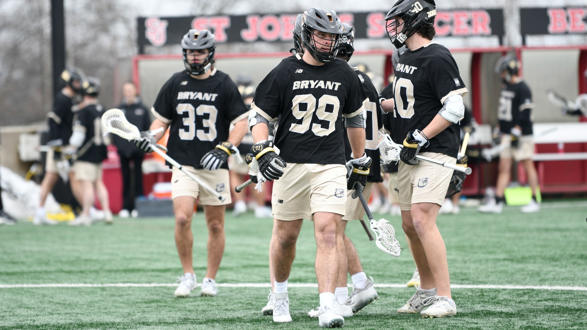 Luke Mead standing in front of his teammates