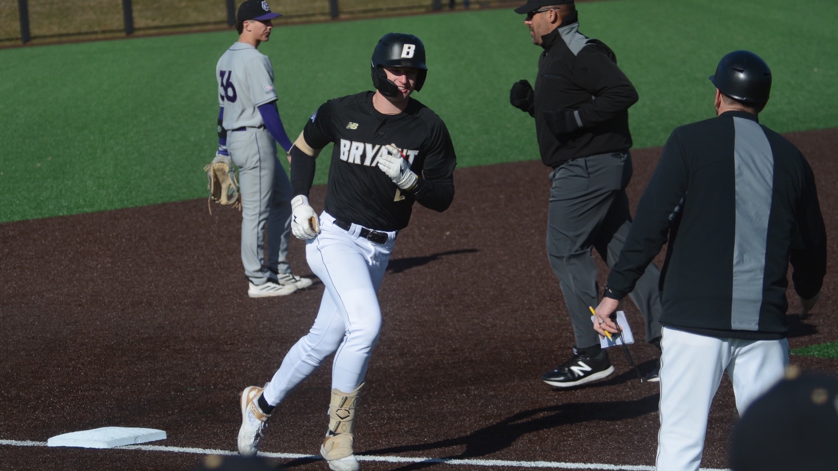 Hunter Kingsbury round third on a home run against Holy Cross